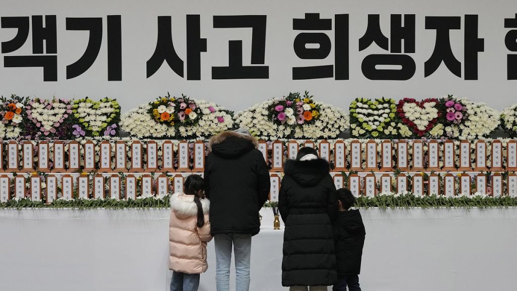 Mourners pray for the victims of a plane crash at a memorial altar at Muan sport park, 30 December, 2024