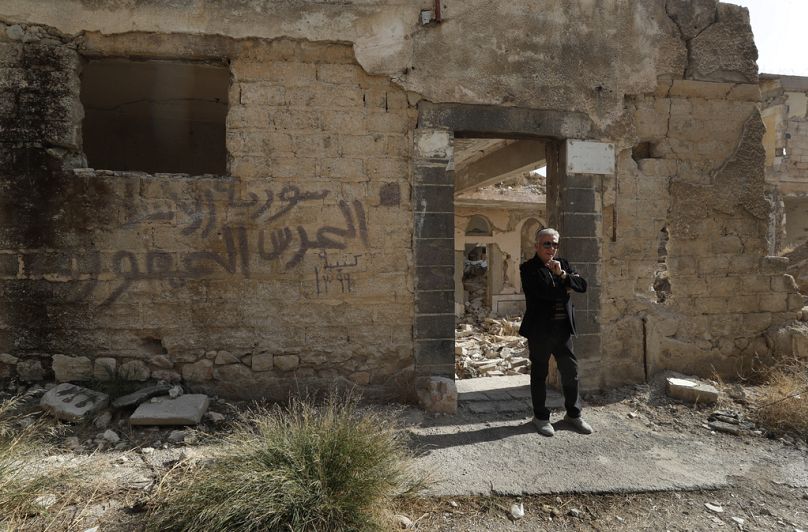 Bakhour Chamantoub, 74 ans, à droite, chef de la communauté juive de Syrie, se tient devant la synagogue Jobar détruite.