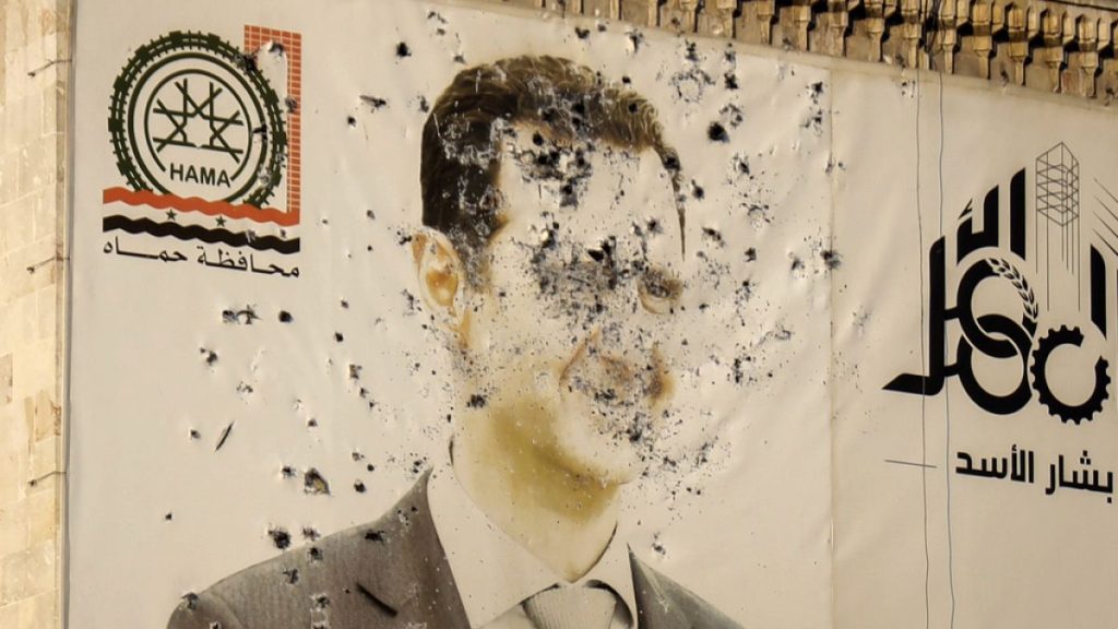 A destroyed poster of Bashar al-Assad