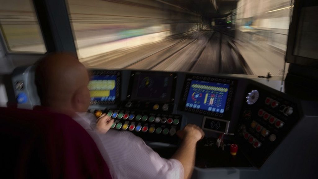 A subway driver operates the train