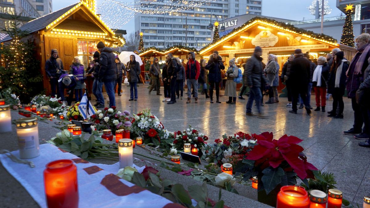 Candles burn at a memorial site at the Christmas market in Berlin, Germany, Dec. 19, 2018 to honor the victims of the Christmas market terrorist attack