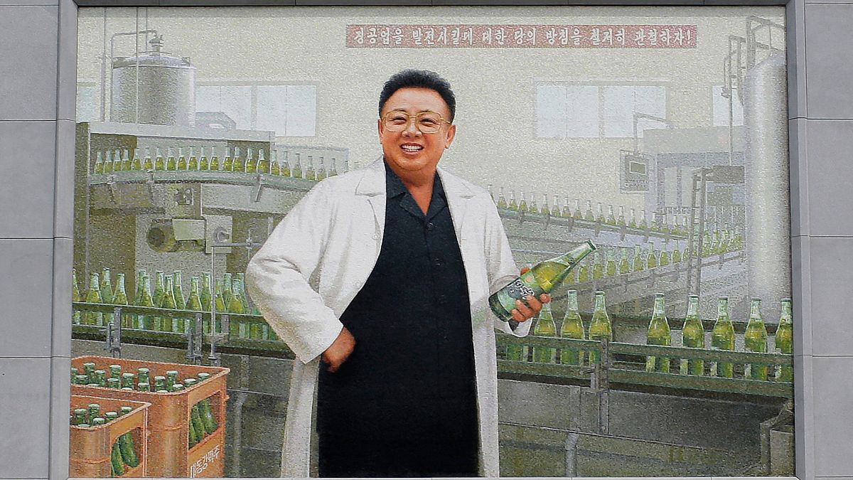 A mural of the late North Korean leader Kim Jong Il in a white lab coat holding up a bottle of beer is seen at the entrance of the Taedonggang Brewery in Pyongyang,