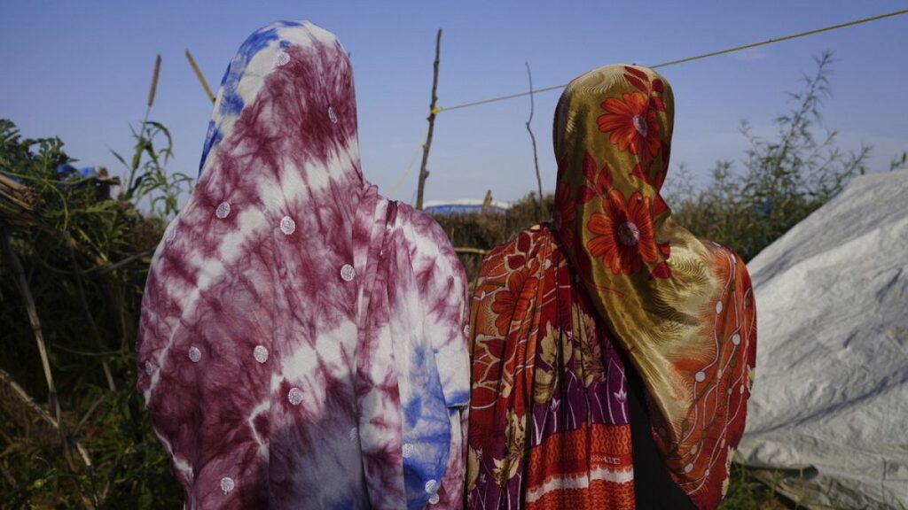 FILE PHOTO: Women who fled war in Sudan and requested anonymity because they feared retribution after reporting rape walk in a refugee camp in Adre, Chad, 5 October, 2014