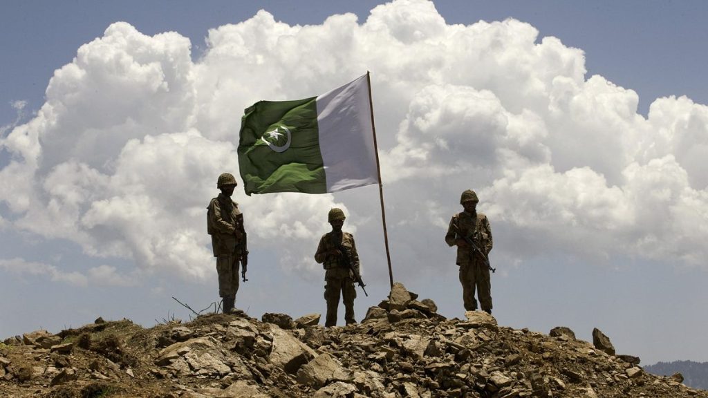 FILE: A Pakistani flag flies over government troops installed on top of a defence position on a former base of Taliban militants overlooking the Swat Valley, 22 May 2009