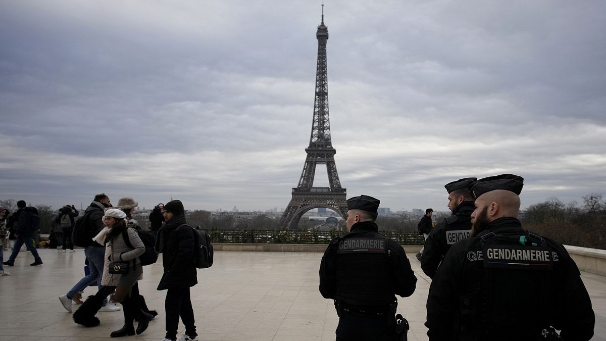 French gendarmes patrol the Trocadero plaza near the Eiffel Tower, 3 December 2023