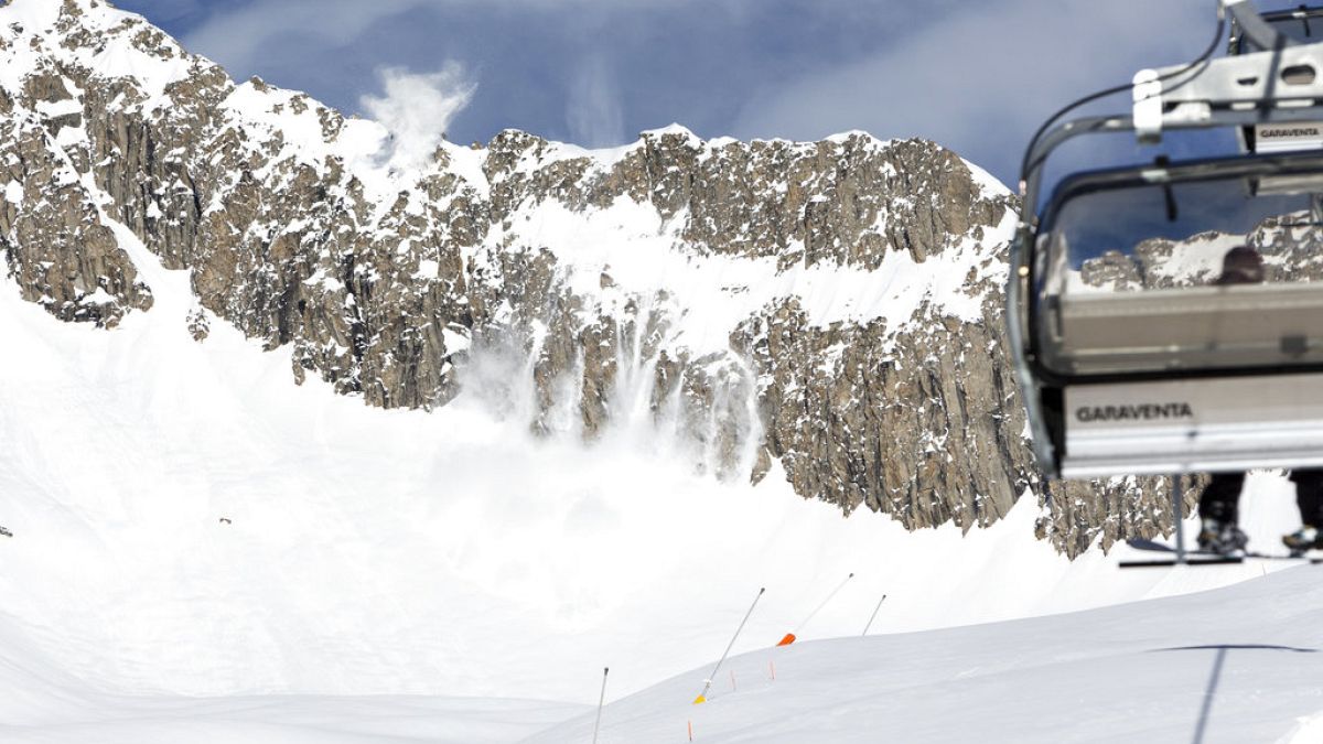 The slope patrol in a helicopter of Air Zermatt is throwing explosive material out of the window to artificially blow up avalanches this noon at the skiing resort Belalp, 2018