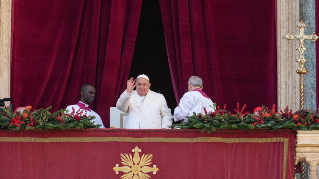 Pope Francis waves before delivering the Urbi et Orbi (Latin for