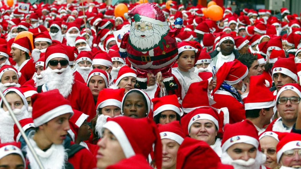 A mustering of people dressed as Santa Claus stroll along a street in Porto, northern Portugal, during a Santa Claus march, Sunday, Dec. 19, 2004