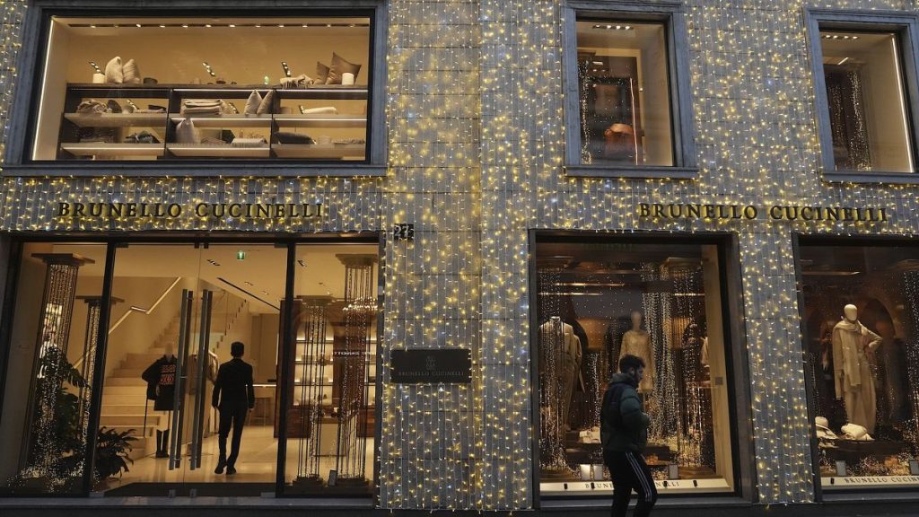 A man walking past a shop in Monte Napoleone street, Milan, Italy