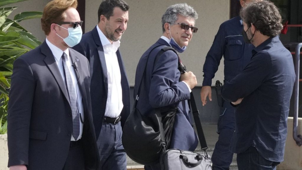 Former minister of interior Matteo Salvini, second from left, walks past Open Arms founder Oscar Camps, right, outside Palermo