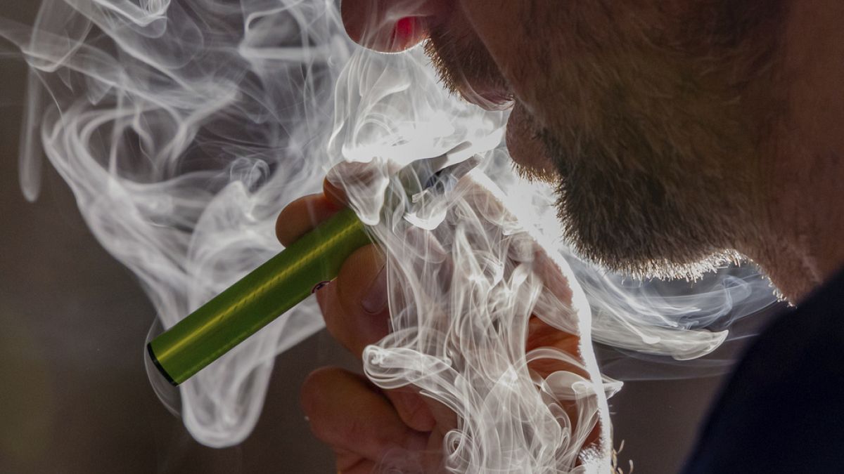 FILE - A man vapes on a disposable electronic cigarette in Brussels on Dec. 12, 2024, ahead of Belgium