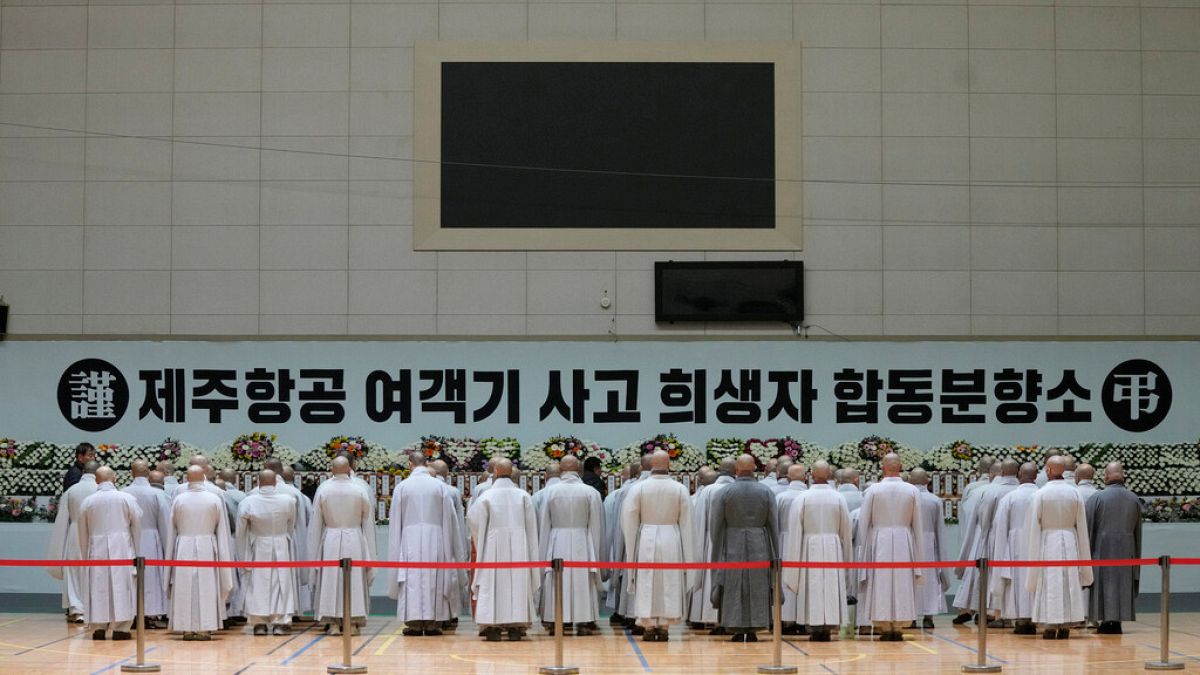 Buddhists monks pray for the victims on a plane which skidded off a runway and burst into flames, at a memorial altar at Muan sport park in Muan, South Korea, 2024.