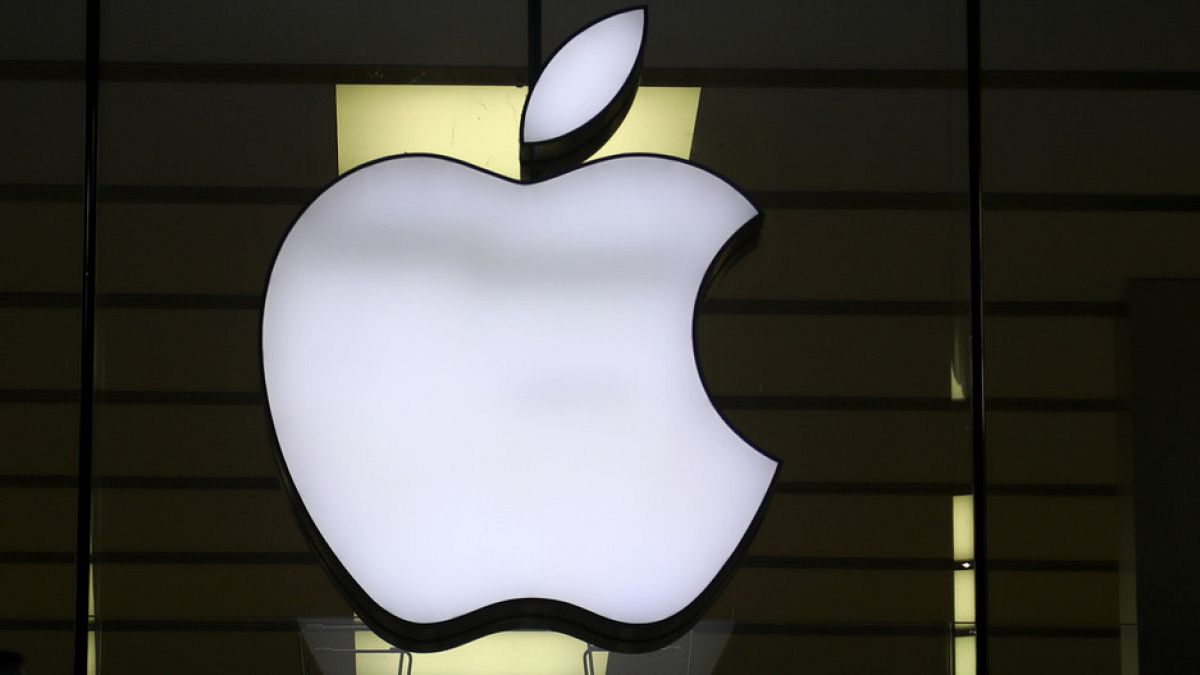 FILE: The logo of Apple is illuminated at a store in the city center in Munich, Germany, on 16 December, 2020.