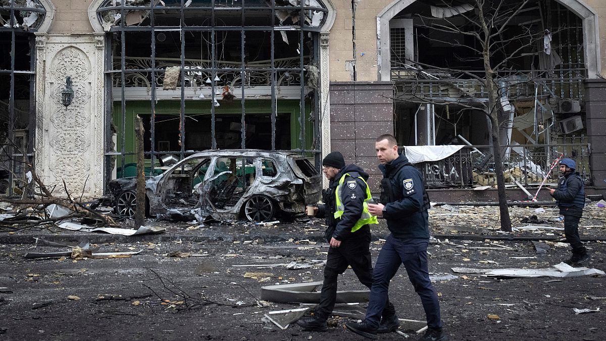 Police officers walk past buildings destroyed by recent Russian attacks in Kyiv, Ukraine, Friday, 20 December 2024.