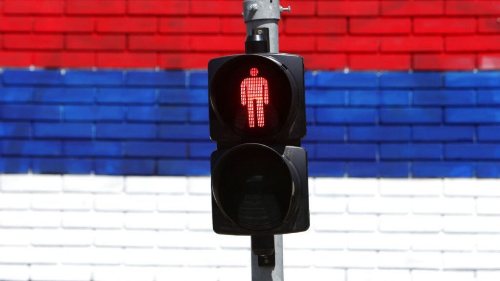 File photo: A wall that shows the colours of the Serbian flag behind traffic light in Belgrade, Serbia, Tuesday, May 18, 2021.