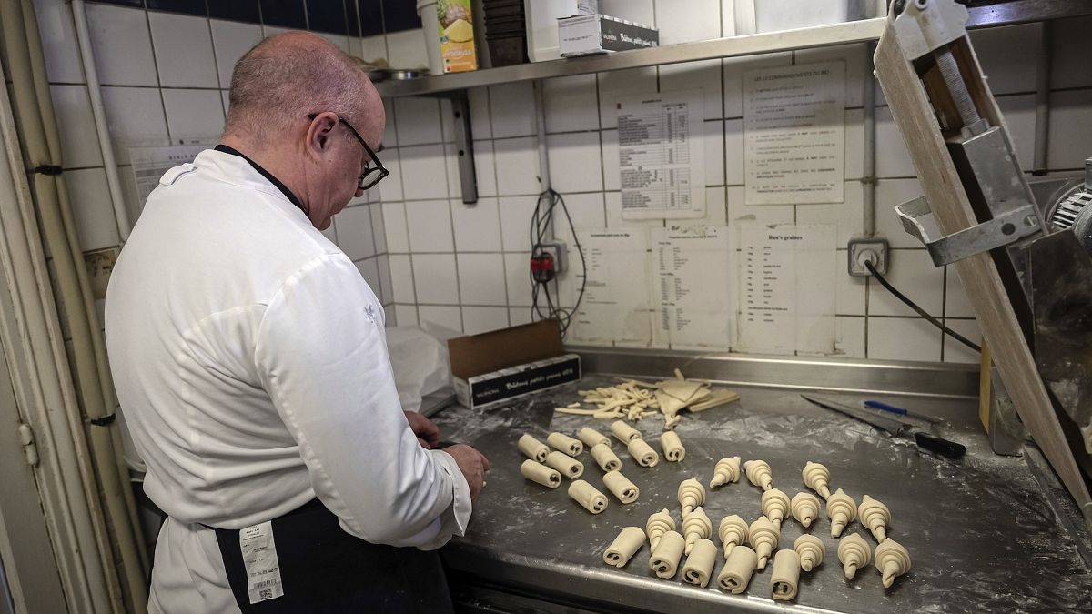 French baker Arnaud Delmontel bakes butter croissants and pains au chocolat in his bakery in Paris