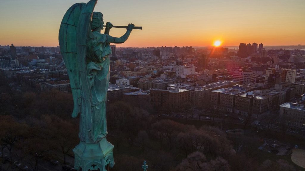 FILE - The Archangel Gabriel blowing a trumpet stands at the Cathedral of St. John the Divine, March 2023