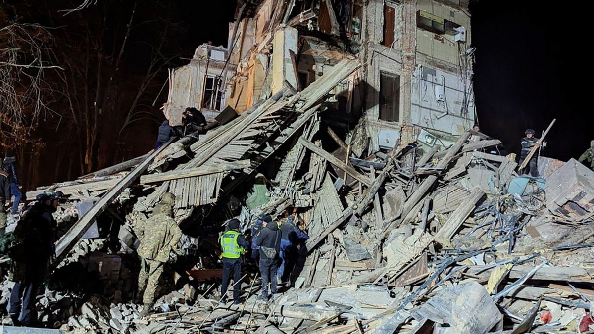 Firefighters work on a site of an apartment building destroyed by a Russian attack in Kryvyi Rih, 25 December 2024