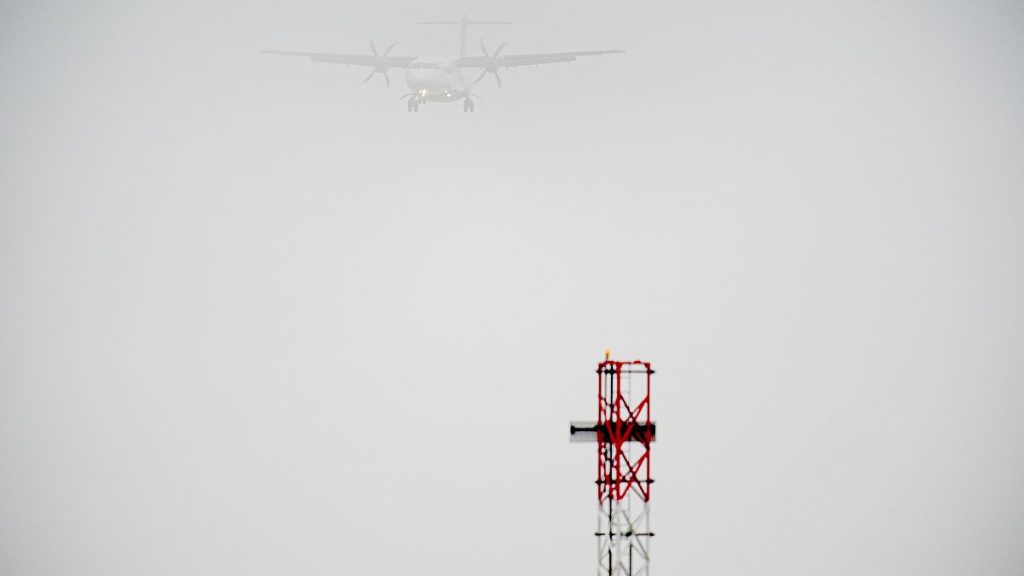 A plane lands in the mist at Cardiff Airport, in Cardiff, Wales, Saturday, Dec. 28, 2024.