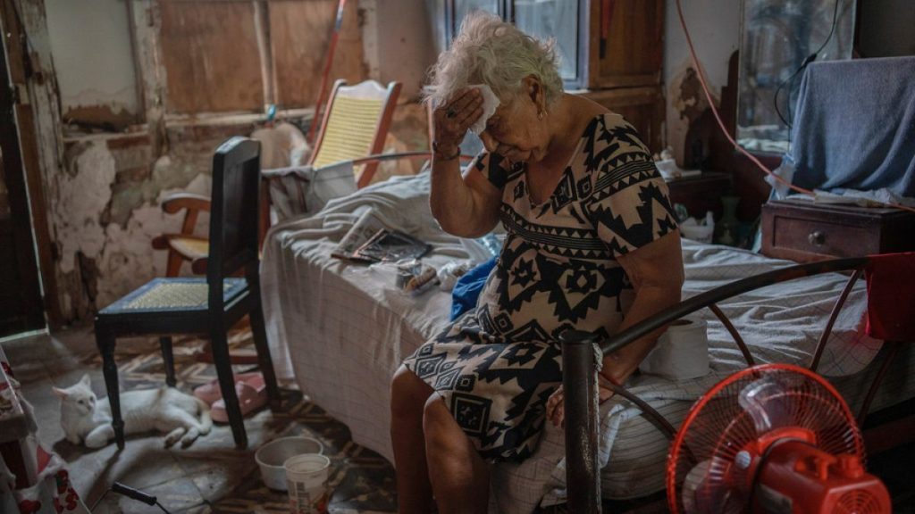 Margarita Salazar, 82, wipes sweat from her forehead in her home during an extreme heat wave in Veracruz, Mexico, on June 16, 2024.