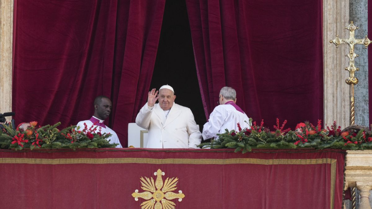 Pope Francis waves before delivering the Urbi et Orbi Christmas