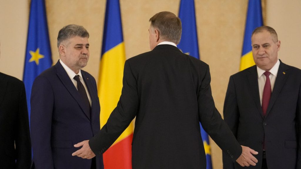 Romanian President Klaus Iohannis, gestures as he speaks with Romanian Prime Minister Marcel Ciolacu, at the end of a swearing in ceremony in Bucharest, Romania, Dec. 23, 2024