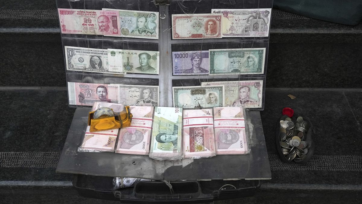 File picture of current and pre-revolution Iranian banknotes and foreign currencies are displayed by a vendor in the commercial district of Tehran