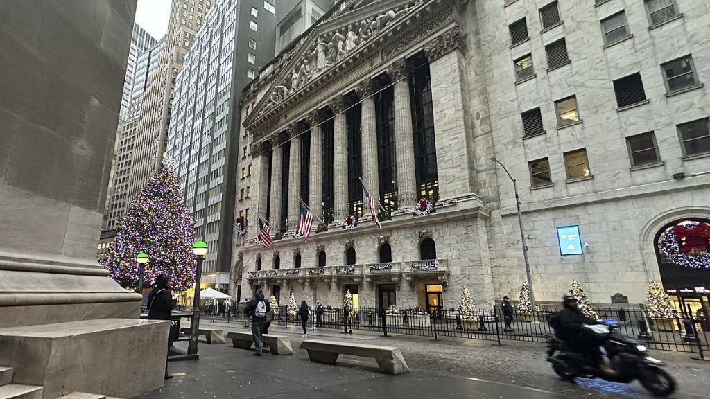 A scooter passes the New York Stock Exchange in New York