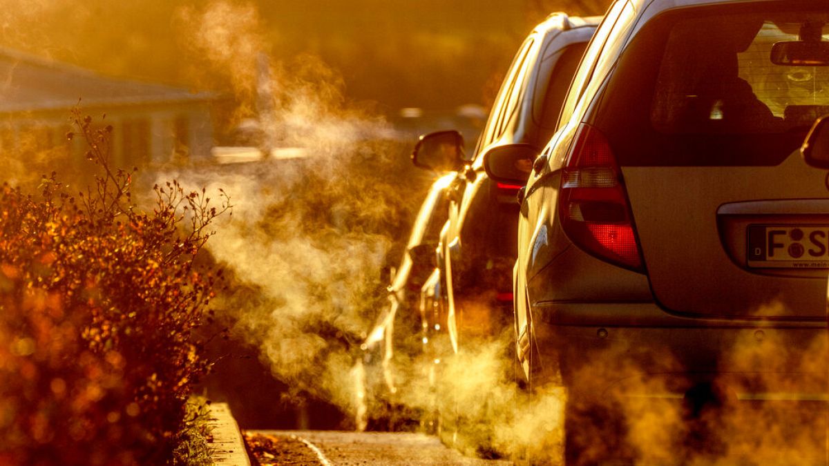 Pollution rises from car exhausts driving on a road in a residential area in Frankfurt, Germany, early Monday, Feb. 27, 2023