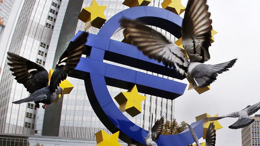 File picture of pigeons fly in front of the Euro sculpture at the old European Central Bank building in Frankfurt