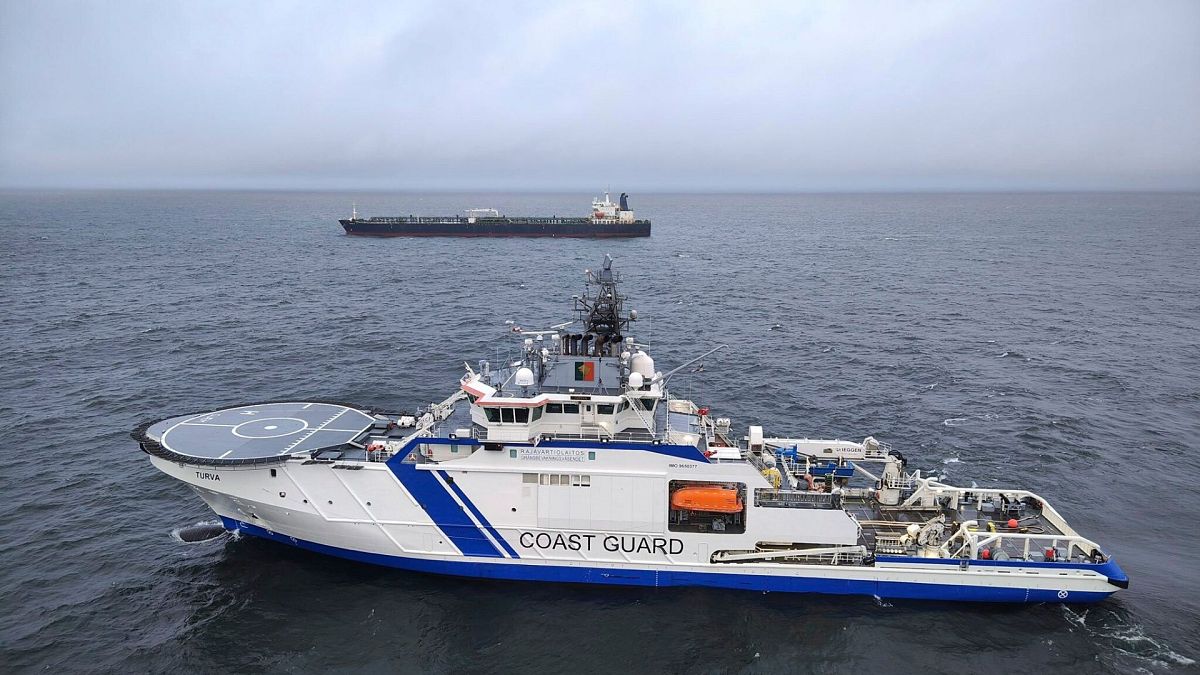 This photo provided by Rajavartiosto (Finnish Border Guard) on Thursday, 26 Dec 2024, shows the oil tanker Eagle S, background, and the Finnish Border Guard ship Turva.