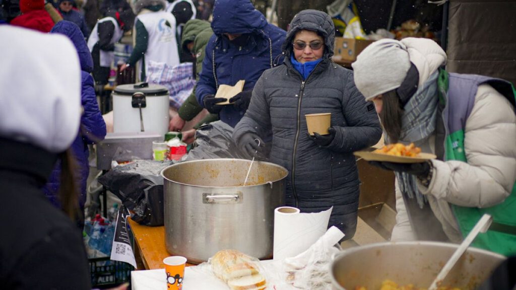 FILE PHOTO - Volunteers serve hot food to refugees fleeing the conflict from neighbouring Ukraine at the Romanian-Ukrainian border, in Siret, Romania, Wednesday, March 2, 2022