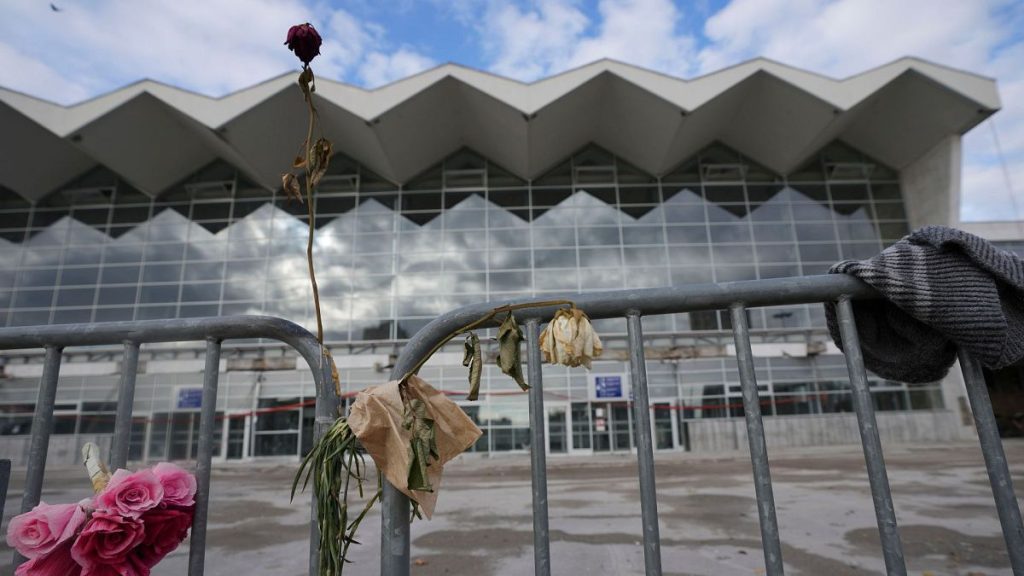 Flowers placed in front of a train station where an outdoor roof collapsed one month ago in Novi Sad, Serbia, Sunday, 1 December 2024