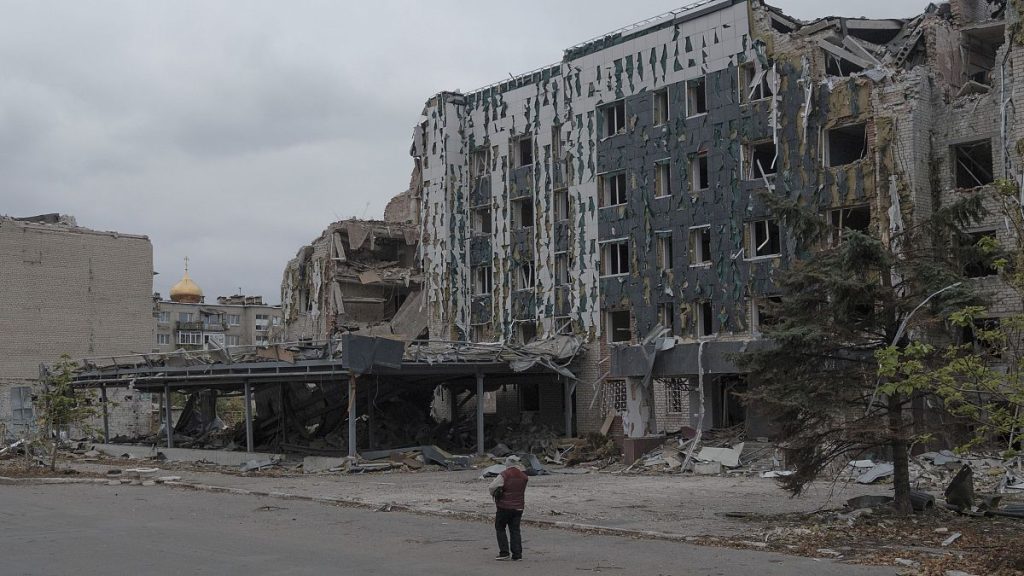 A woman walks in front of Druzhba hotel destroyed by Russian airstrikes in Pokrovsk, Monday, Nov. 11, 2024