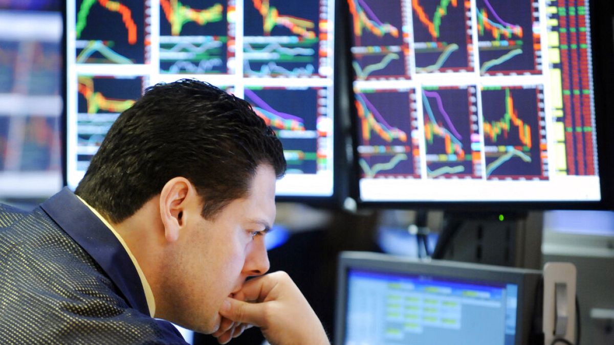 A specialist studies his screens as he works on the floor of the New York Stock Exchange, Friday, Oct. 10, 2008.