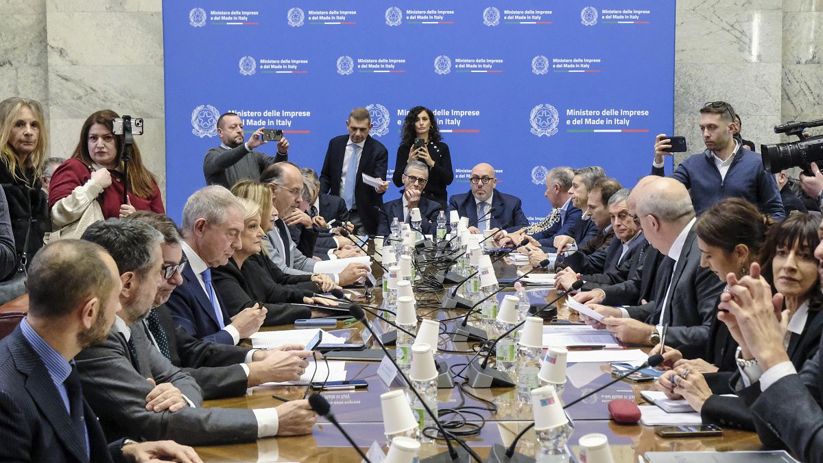 Executives from Stellantis and economic, labor and economic development ministers sit during a meeting held at the Ministry of Enterprise and Made in Italy in Rome.