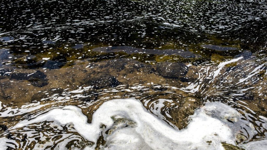 PFAS foam gathers at the the Van Etten Creek dam in Oscoda Township, Mich., near Wurtsmith Air Force Base, US.