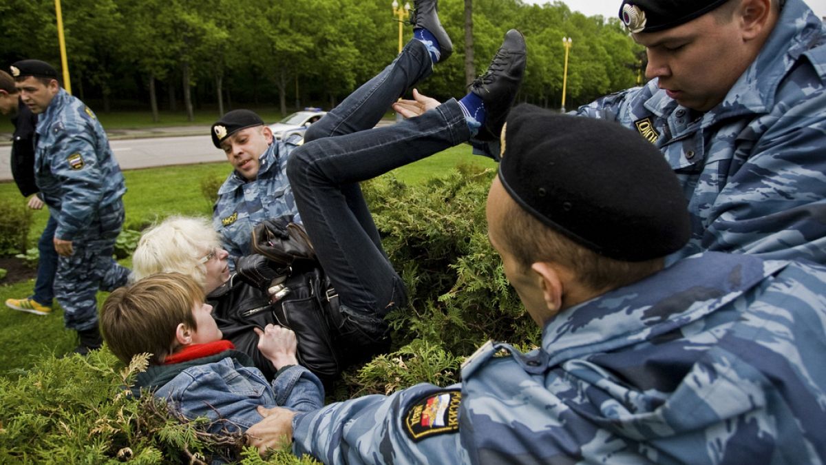 FILE - A Russian Gay Rights protester is taken away by riot police officers in Moscow, Russia, Saturday, May 16, 2009