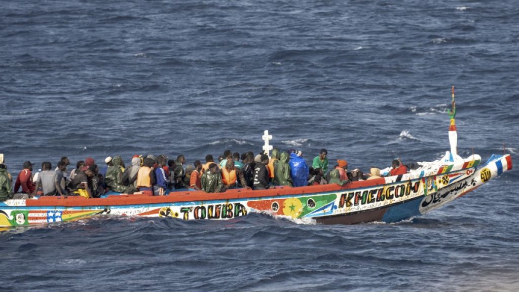 Migrants crowd a wooden boat as they sail to the port in La Restinga on the Canary island of El Hierro, Spain, Monday, Aug. 19, 2024.