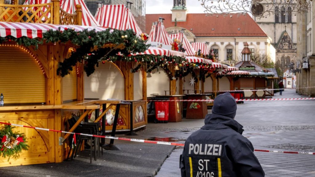 A police officer guards the Christmas Market in Magdeburg, Germany, on Sunday morning, Dec. 22, 2024. (AP Photo/Michael Probst)