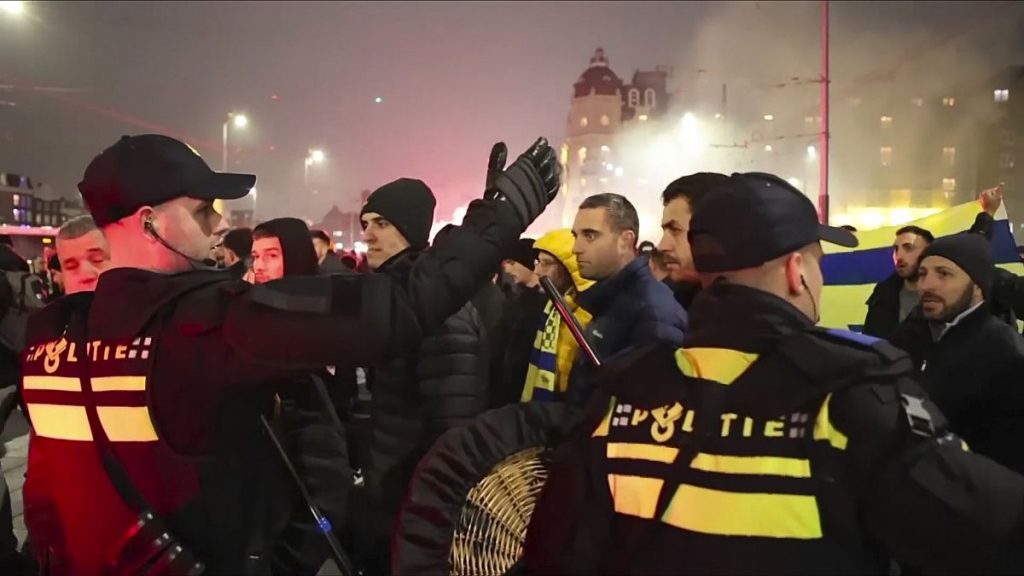 FILE - In this image taken from video, police escort Maccabi Tel Aviv supporters to the metro station leading them to the Ajax stadium, 7 November 2024