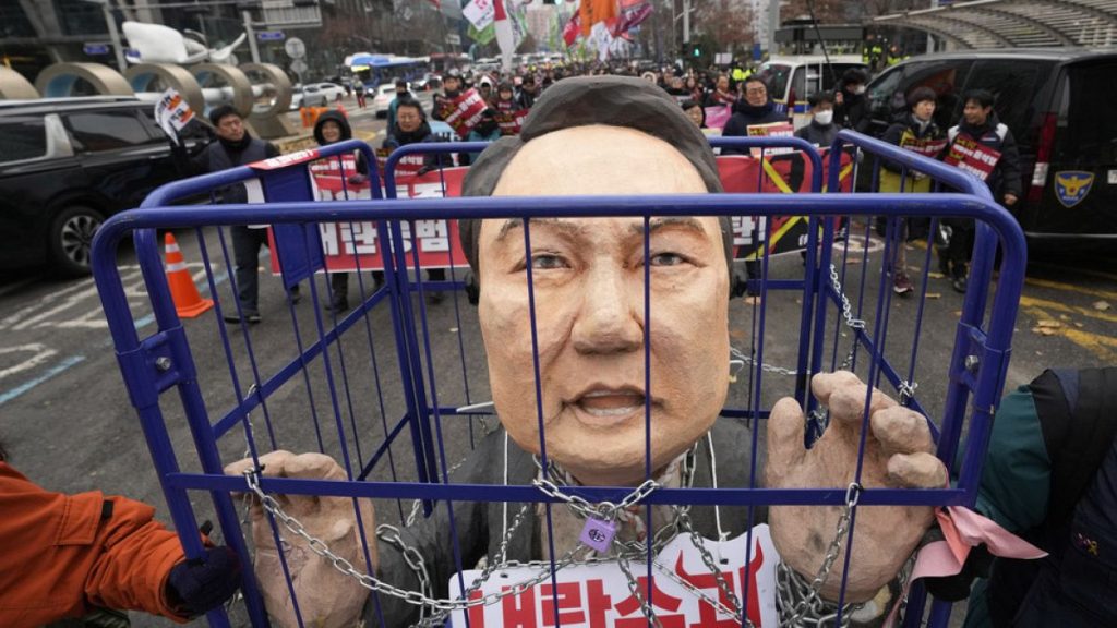 Protesters carry a caricature of impeached South Korean President Yoon Suk Yeol during a rally demanding his arrest in Seoul, South Korea, Saturday, Dec. 21, 2024