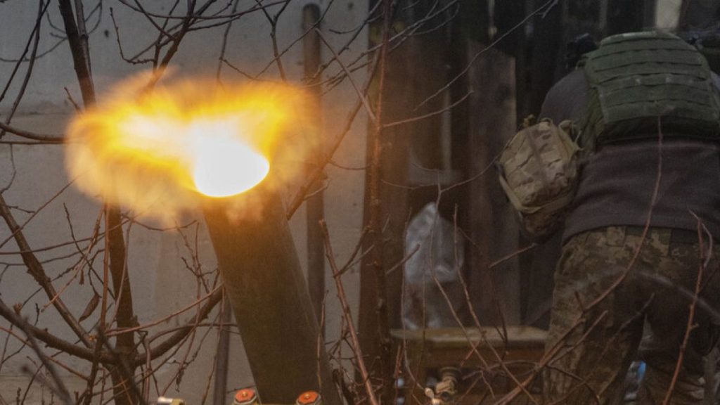 A Ukrainian serviceman of the 57th Mechanised Brigade fire 120mm mortar towards Russian positions near Kharkiv, Ukraine, Tuesday, Dec. 24, 2024