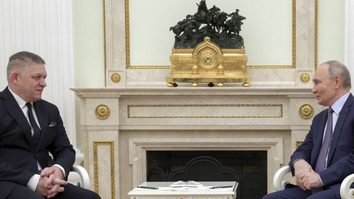 Russian President Vladimir Putin, right, and Slovak Prime Minister Robert Fico talk to each other during their meeting at the Kremlin in Moscow, Russia, Sunday, Dec. 22, 2024