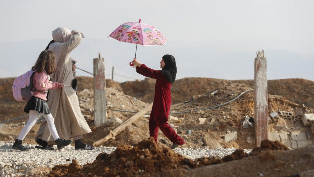 A family arrives to cross into Lebanon through the Jousieh border crossing, between Syria and Lebanon, Nov. 28, 2024, following a ceasefire between Israel and Hezbollah.