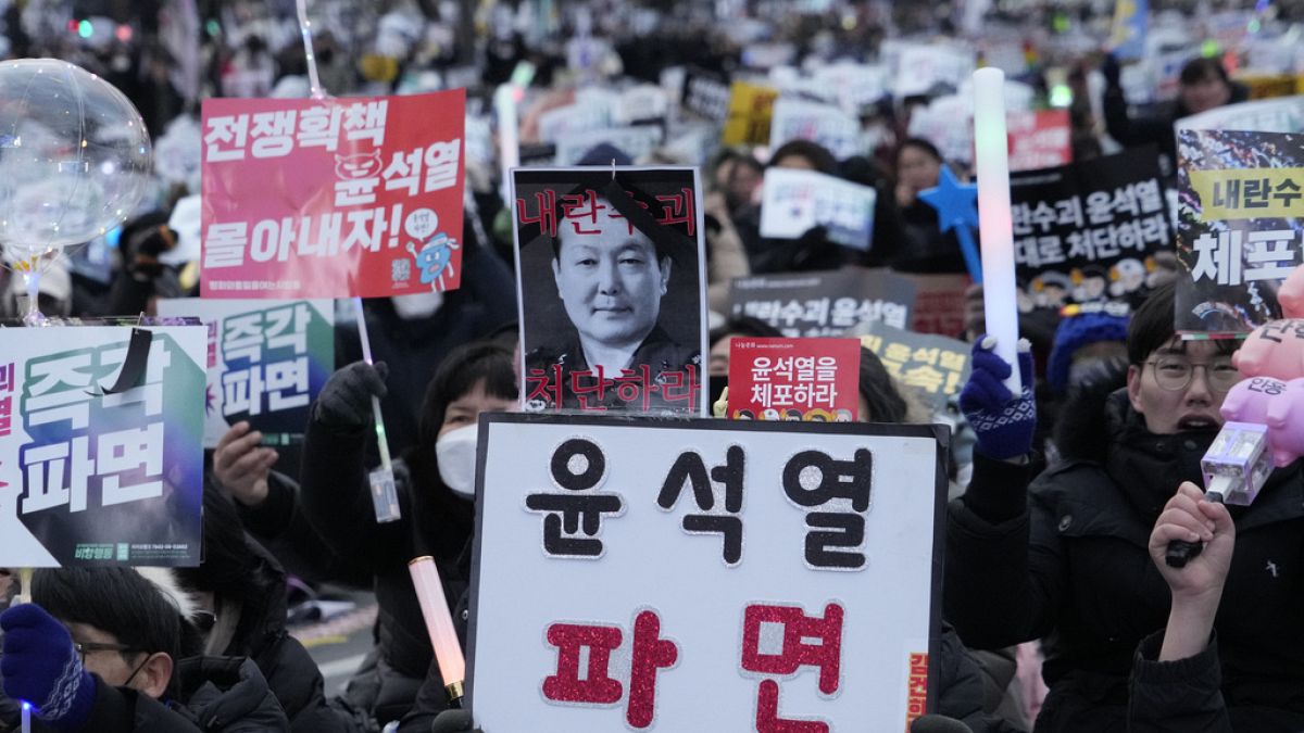 Protesters attend a rally demanding the arrest of impeached South Korean President Yoon Suk Yeol in Seoul, South Korea, Saturday, Jan. 4, 2025. The letters read