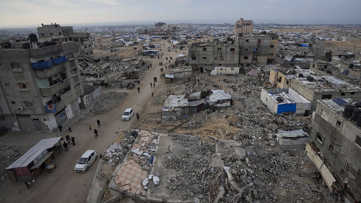 A tent camp for displaced Palestinians is set up amid destroyed buildings in the Khan Younis refugee camp, 4 January, 2025