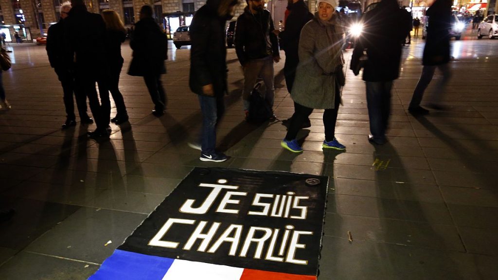 People walk around to banner reading