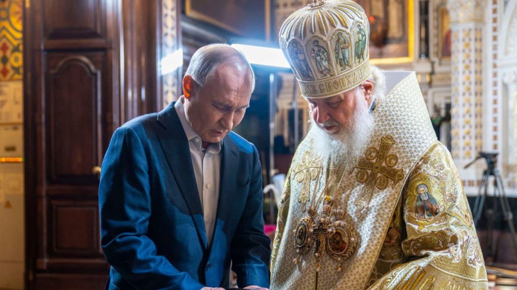 Russian President Vladimir Putin, left, and Russian Orthodox Patriarch Kirill speak after the Christmas service in the Christ The Saviour Cathedral in Moscow, Russia, Tuesday.