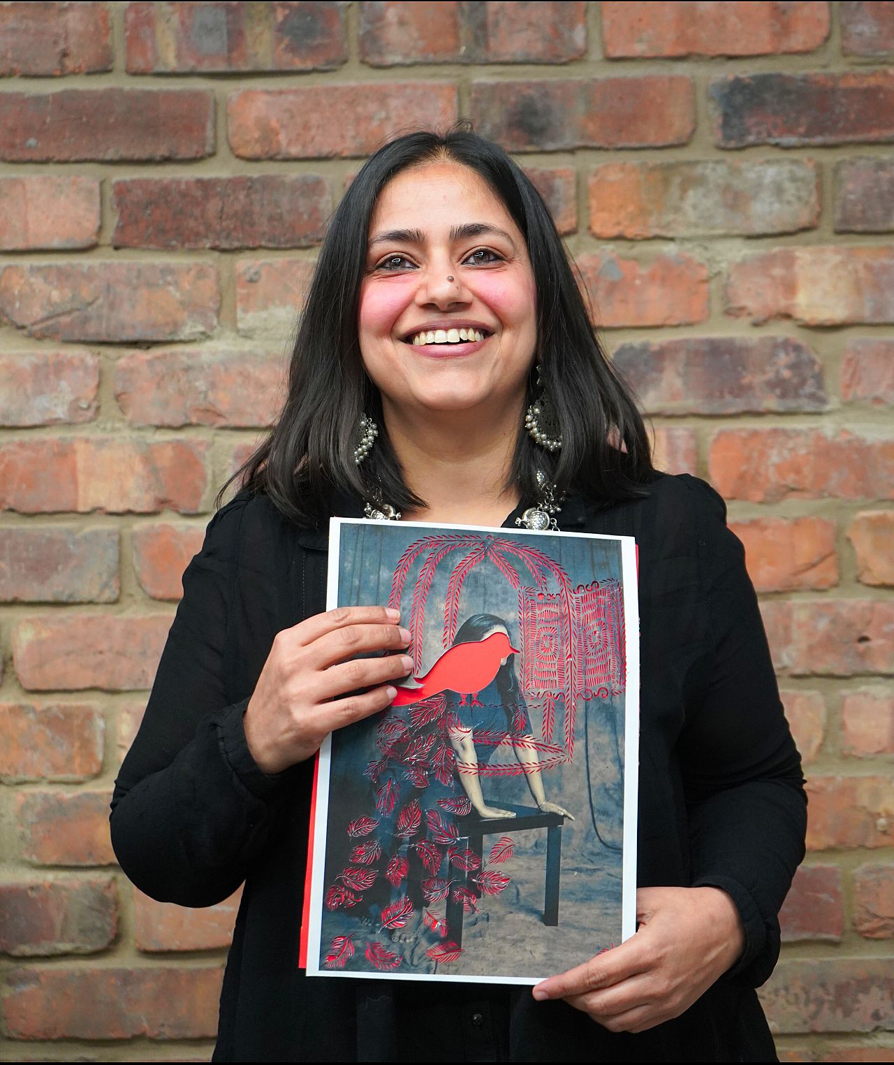 Sujata Setia photographed with one of the original works from her 'A Thousand Cuts' series 